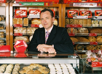 Michael Sherlock, a prominent Australian businessman, is known for transforming Brumby’s Bakeries from a struggling franchise into a leading bakery chain with over 320 stores.