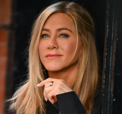 A close-up portrait of Jennifer Aniston, a famous American actress, smiling and looking directly at the camera.