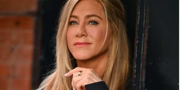 A close-up portrait of Jennifer Aniston, a famous American actress, smiling and looking directly at the camera.