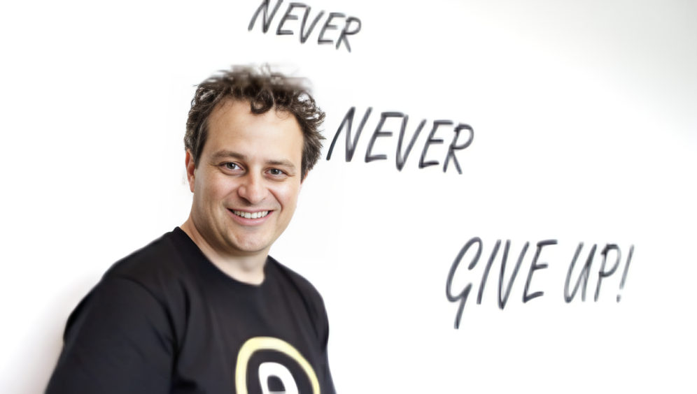 Matt Bullock, founder and CEO of eWAY, an Australian fintech company, standing confidently in a business setting, symbolizing his leadership in revolutionizing online payments.