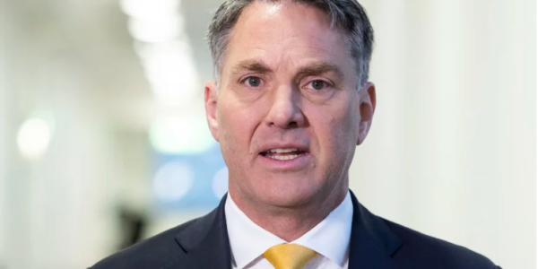 Richard Marles MP, in formal attire, addressing the media as Australia’s Deputy Prime Minister and Minister for Defence, focusing on national security initiatives.