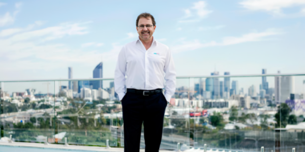 John O'Brien, founder and CEO of Poolwerx, stands proudly in front of a Poolwerx service vehicle, symbolizing his leadership and innovation in the pool maintenance and franchising industry.