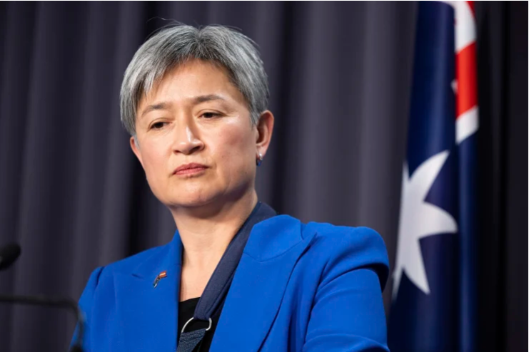 Penny Wong, an influential Australian politician and Minister for Foreign Affairs, speaks at a podium, exuding confidence and determination.