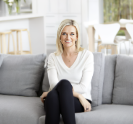 Kristina Karlsson, founder of kikki.K and Dream Life, smiling warmly as she stands in a bright, creative workspace filled with stylish stationery and design elements, reflecting her passion for inspiring others to pursue their dreams.