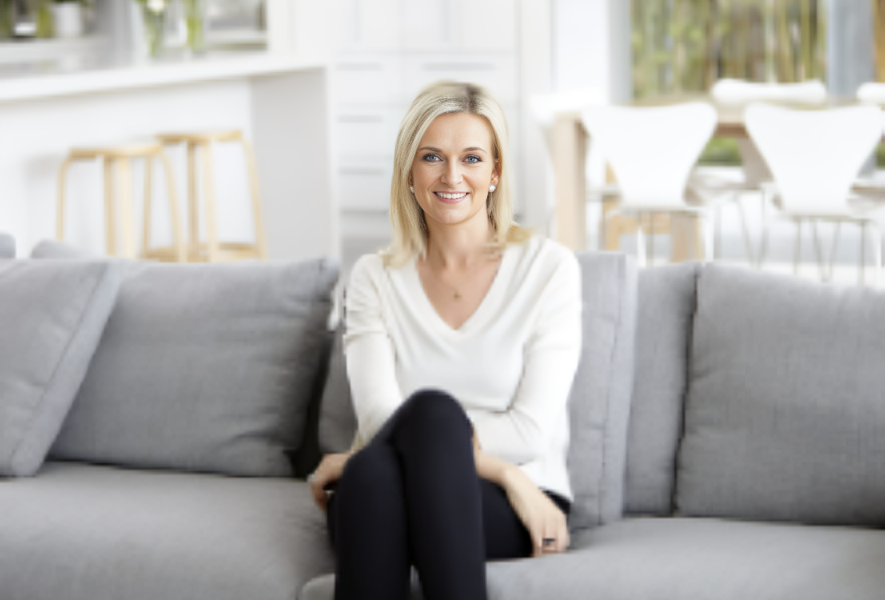 Kristina Karlsson, founder of kikki.K and Dream Life, smiling warmly as she stands in a bright, creative workspace filled with stylish stationery and design elements, reflecting her passion for inspiring others to pursue their dreams.