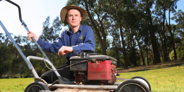 Jim Penman, an Australian businessman and historian, wearing a suit and smiling confidently. He is the founder and CEO of Jim's Group, known for its lawn care franchise and extensive service network.