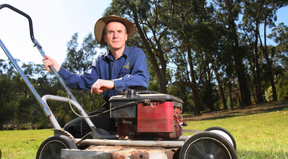 Jim Penman, an Australian businessman and historian, wearing a suit and smiling confidently. He is the founder and CEO of Jim's Group, known for its lawn care franchise and extensive service network.