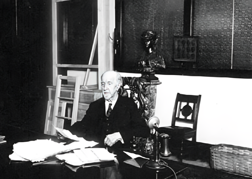 T. B. Walker, a distinguished businessman known for his contributions to the lumber industry and the arts, standing in front of his historic art gallery in Minneapolis.