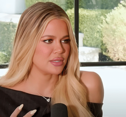 Khloé Kardashian smiling in a stylish outfit, promoting her fashion brand Good American.