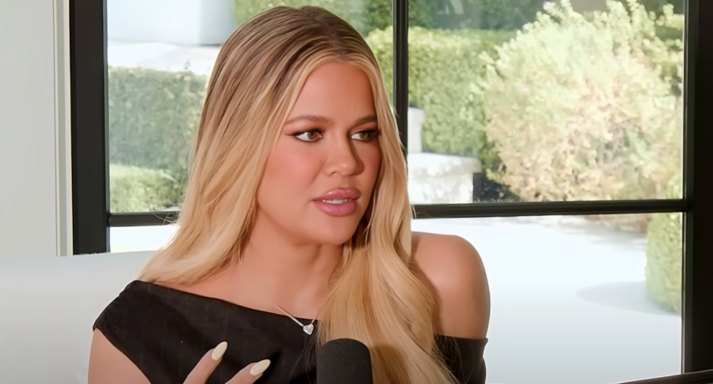 Khloé Kardashian smiling in a stylish outfit, promoting her fashion brand Good American.