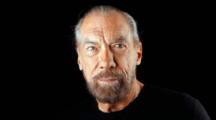 John Paul DeJoria smiling in a professional portrait, co-founder of Paul Mitchell and Patrón Spirits