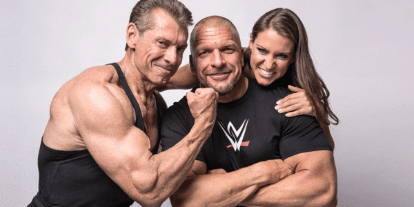 Vince McMahon standing in a suit, representing his role as the visionary leader who transformed WWE into a global entertainment empire.