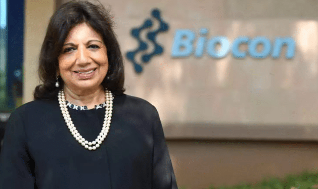 Kiran Mazumdar-Shaw smiling in a professional portrait, wearing a formal blazer, representing her role as a leading Indian biotech entrepreneur.