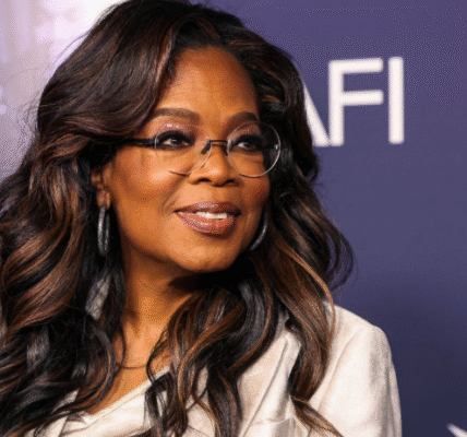 Oprah Winfrey smiling in a professional portrait, wearing a formal outfit, representing her role as a media mogul and influential entrepreneur.