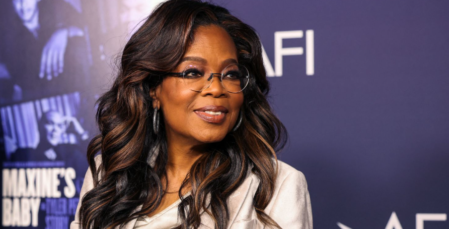 Oprah Winfrey smiling in a professional portrait, wearing a formal outfit, representing her role as a media mogul and influential entrepreneur.